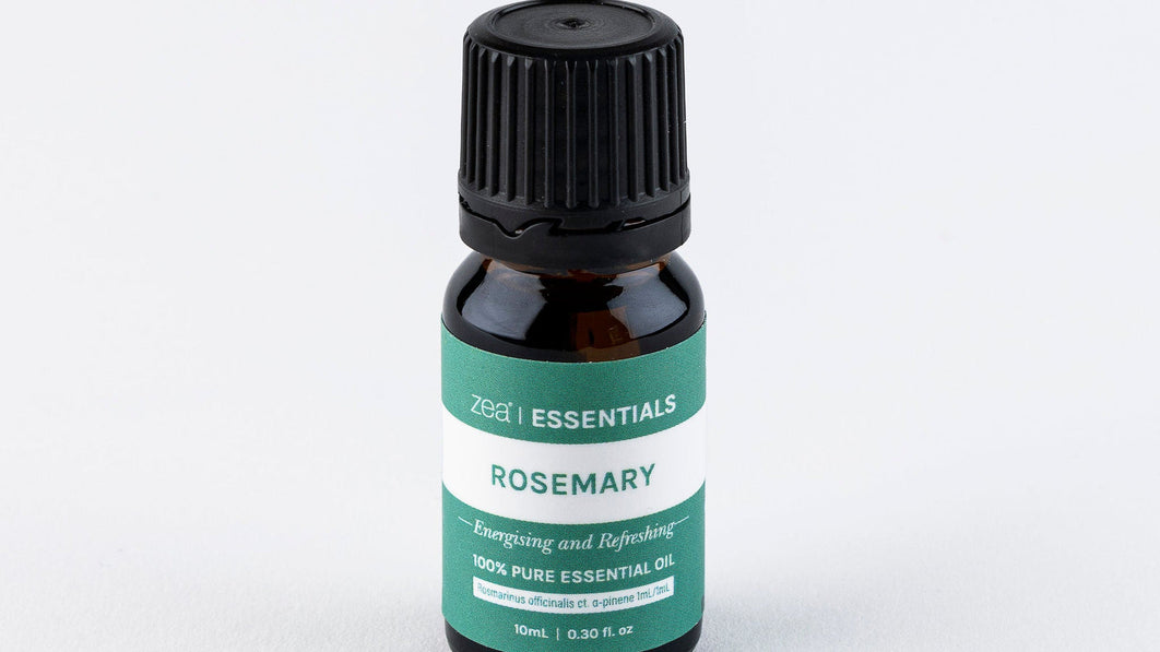 Bottle of Zea Rosemary Essential Oil on a wooden surface