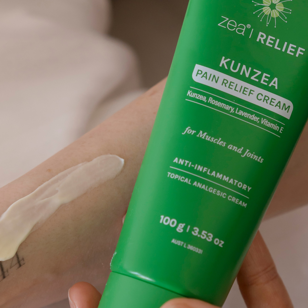 Applying Zea Kunzea Pain Relief Cream from the current 100g tube to an arm
